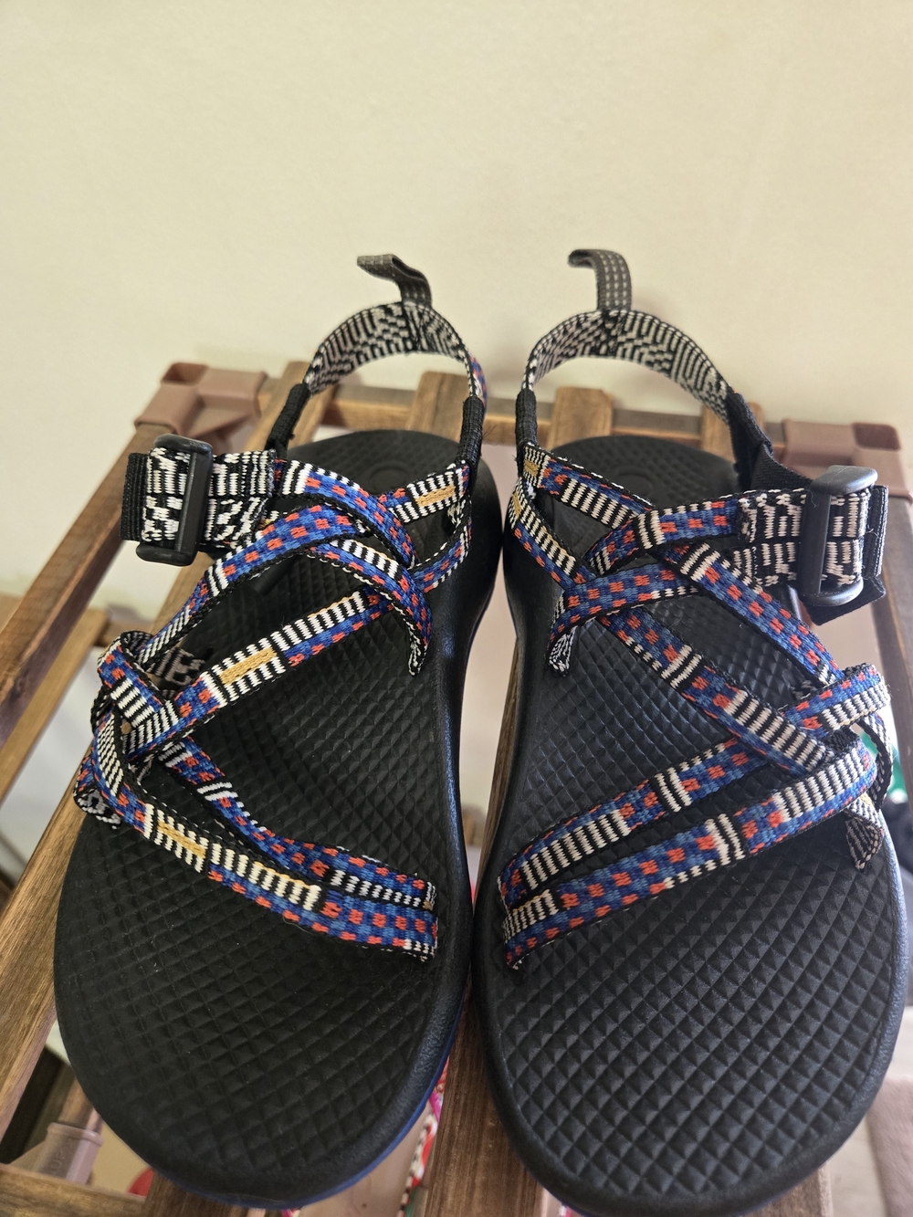 Chaco kids black sandal with blue and orange patterned straps